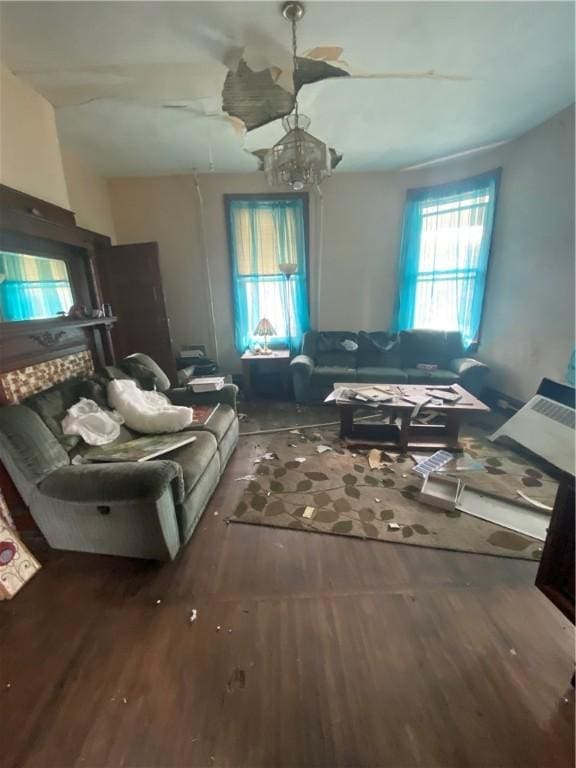 miscellaneous room featuring dark hardwood / wood-style flooring and an inviting chandelier