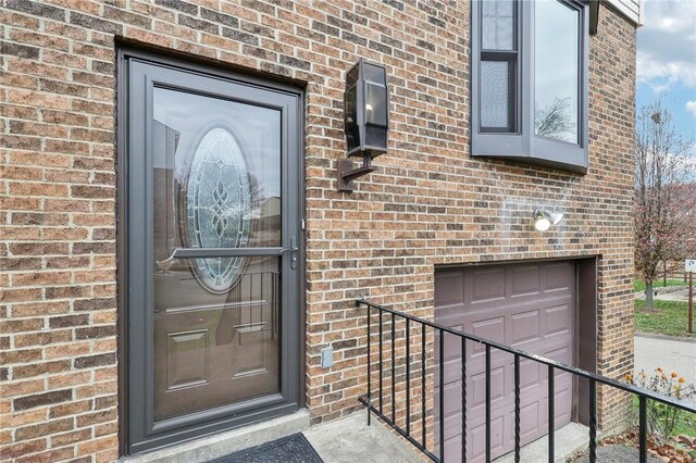 doorway to property with a garage