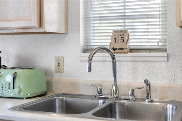 room details featuring sink and light brown cabinets