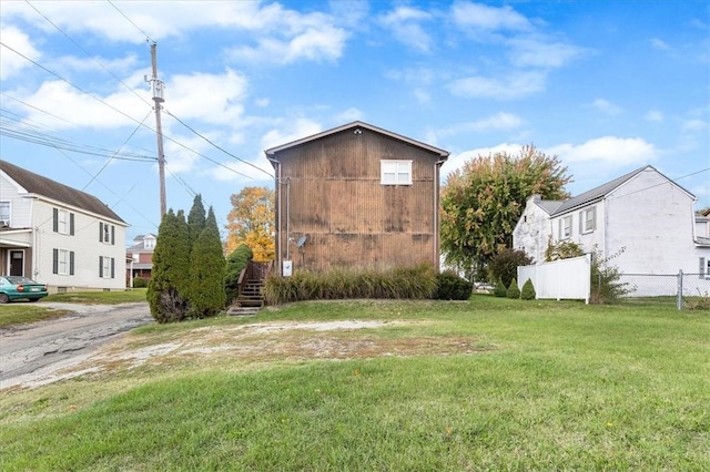 view of side of property featuring a yard