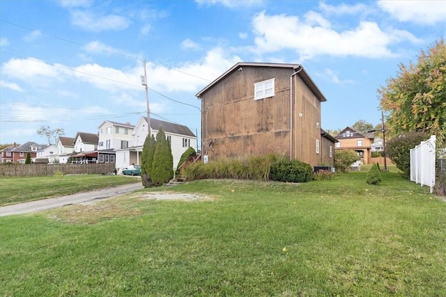 view of side of property with a yard