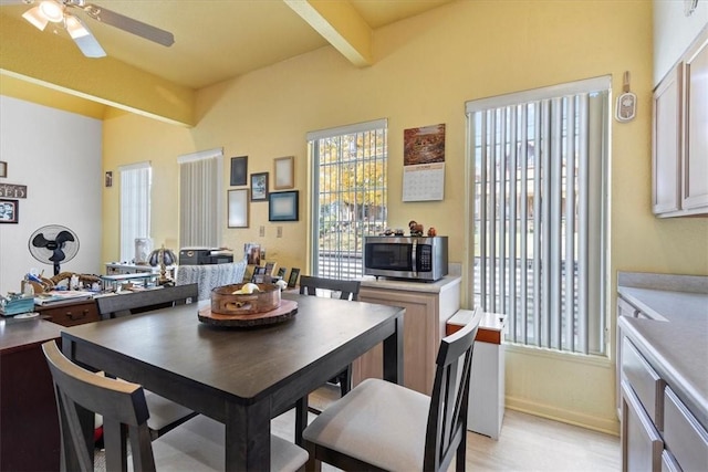 dining room with ceiling fan and beam ceiling