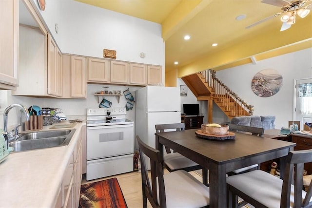 kitchen featuring white appliances, light wood-type flooring, ceiling fan, light brown cabinets, and sink