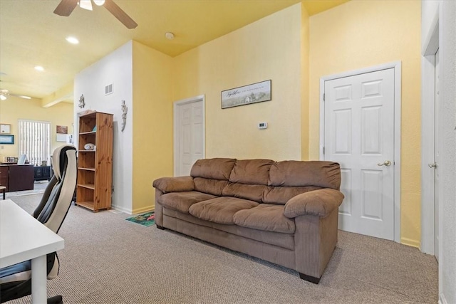 living room with ceiling fan and light colored carpet