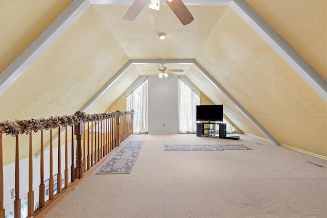 bonus room featuring a textured ceiling, ceiling fan, vaulted ceiling, and carpet floors