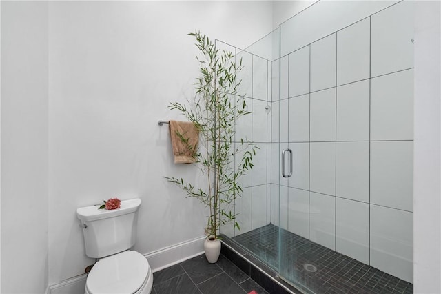 bathroom with tile patterned floors, a shower with shower door, and toilet