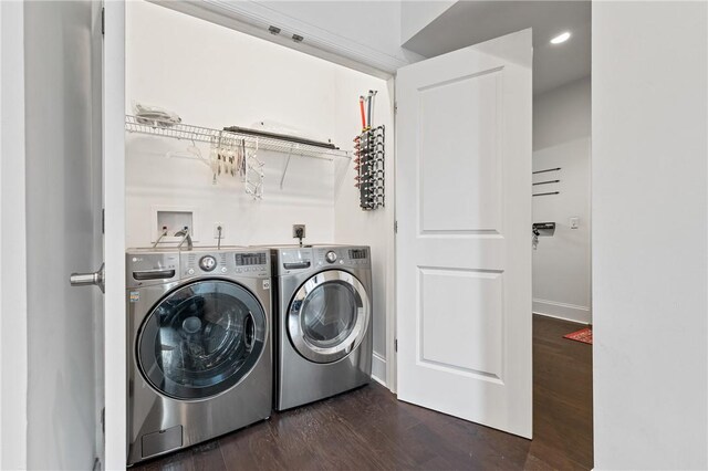 washroom featuring dark hardwood / wood-style flooring and washing machine and clothes dryer