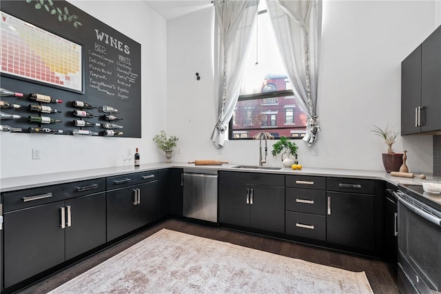 kitchen featuring sink, dark wood-type flooring, and appliances with stainless steel finishes