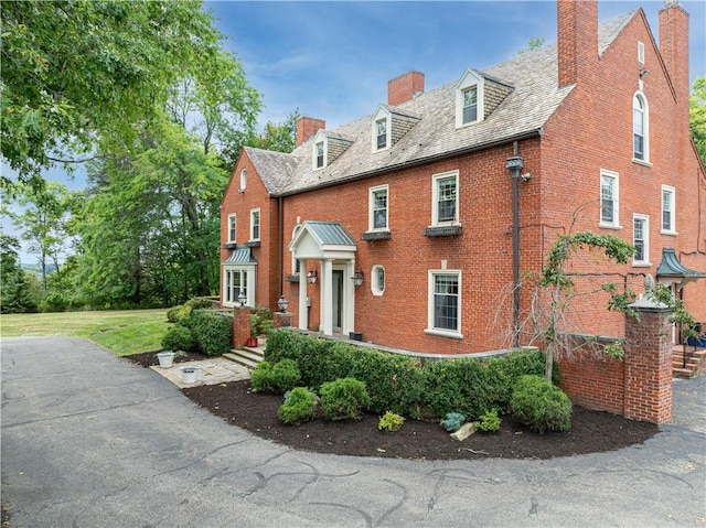 705 E Beau St E, Washington Boro, PA 15301 - view of front of house featuring brick siding, a chimney, and a high end roof