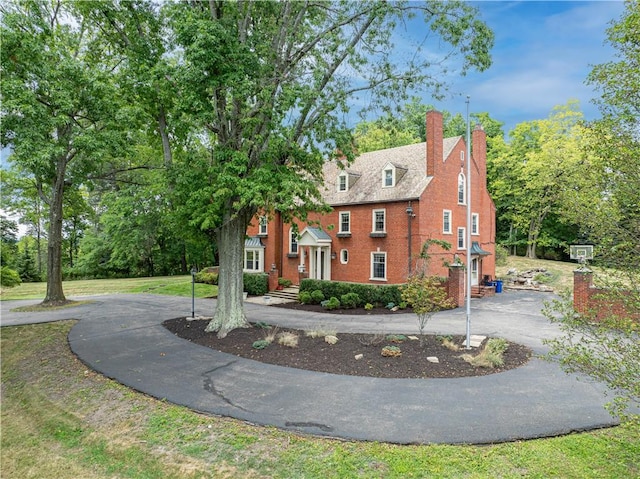 705 E Beau St E, Washington Boro, PA 15301 - view of front of home with curved driveway, brick siding, and a chimney