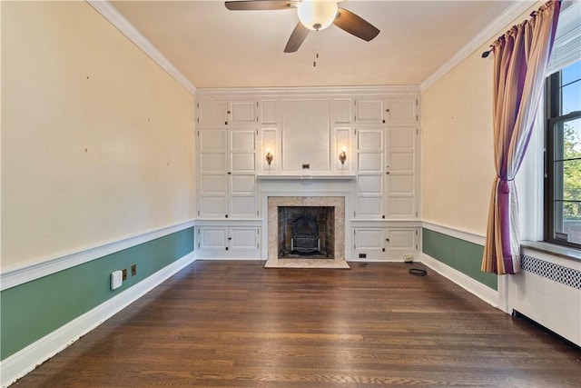 unfurnished living room featuring radiator heating unit, dark hardwood / wood-style floors, ceiling fan, and ornamental molding