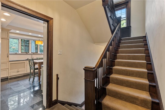 staircase featuring a tray ceiling