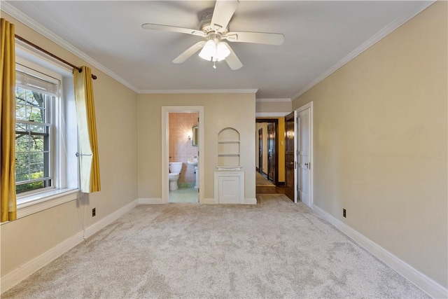 unfurnished bedroom with ensuite bathroom, ceiling fan, light colored carpet, and ornamental molding