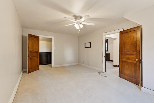 unfurnished bedroom featuring ceiling fan and light colored carpet