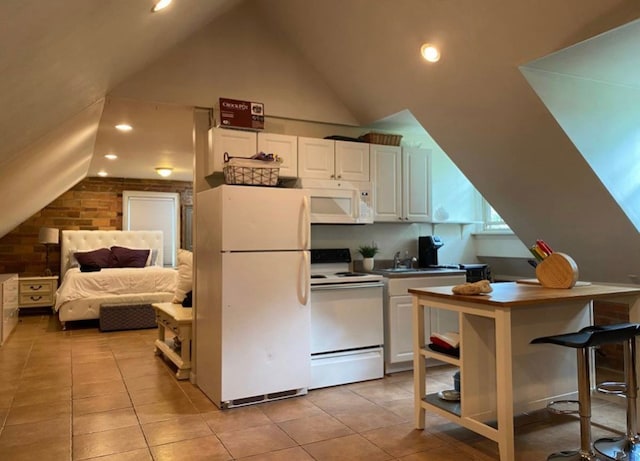 705 E Beau St E, Washington Boro, PA 15301 - kitchen with white appliances, white cabinetry, light tile patterned flooring, vaulted ceiling, and recessed lighting