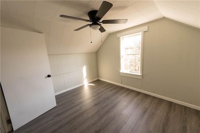 additional living space featuring dark hardwood / wood-style flooring, ceiling fan, and lofted ceiling