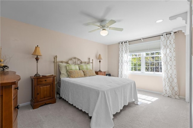 bedroom with light carpet and ceiling fan