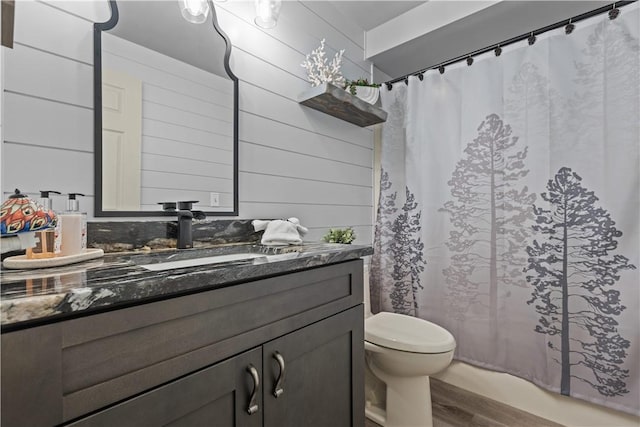 bathroom featuring vanity, toilet, and wood-type flooring