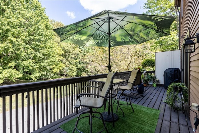 wooden terrace featuring a grill