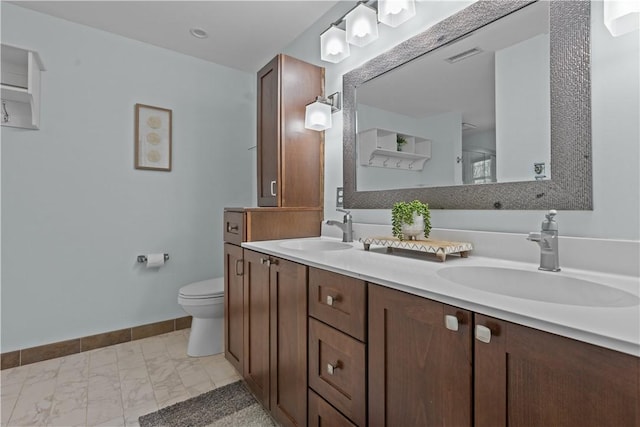 bathroom featuring vanity and toilet