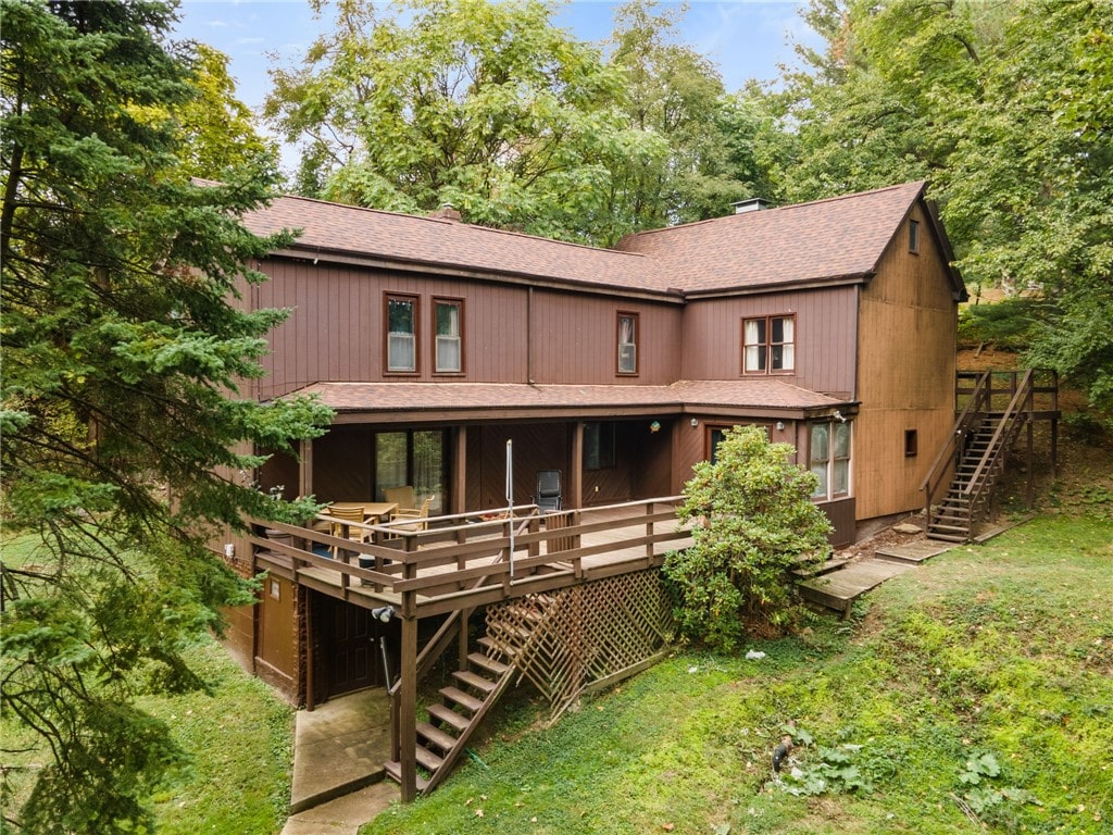 back of property with a wooden deck