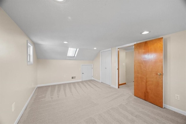 bonus room featuring light colored carpet and lofted ceiling