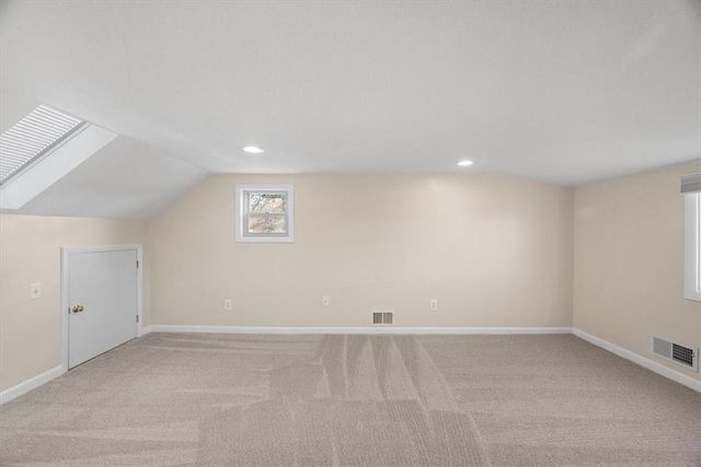 bonus room featuring light colored carpet and lofted ceiling