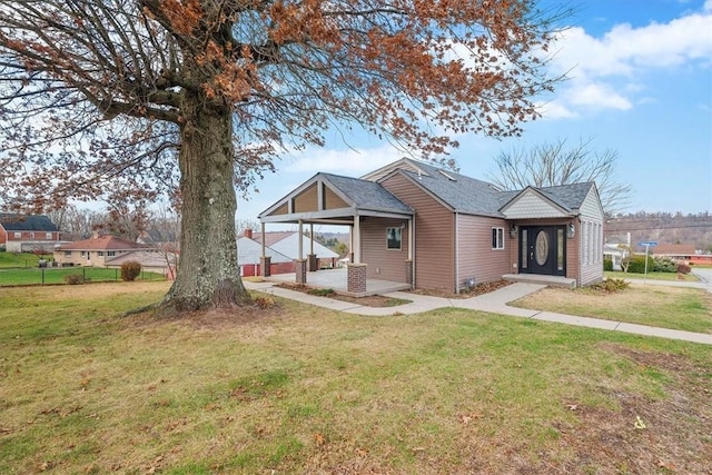 view of front of property with a carport and a front lawn