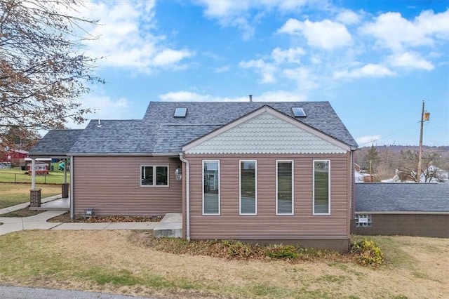 back of house with a lawn