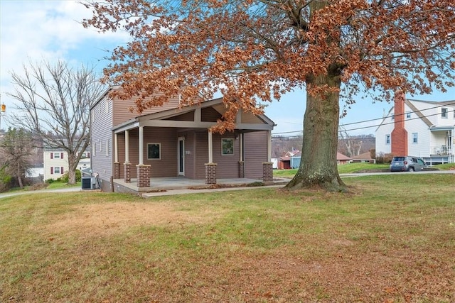 view of front of house with a front lawn and central air condition unit