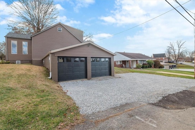 view of side of property featuring a yard and a garage