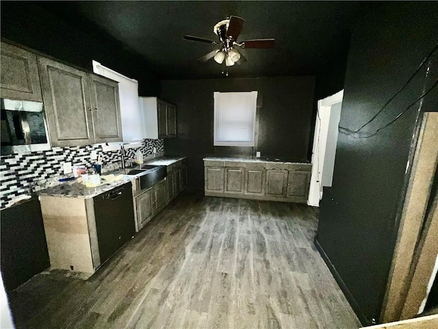 kitchen featuring ceiling fan, dishwasher, sink, wood-type flooring, and decorative backsplash