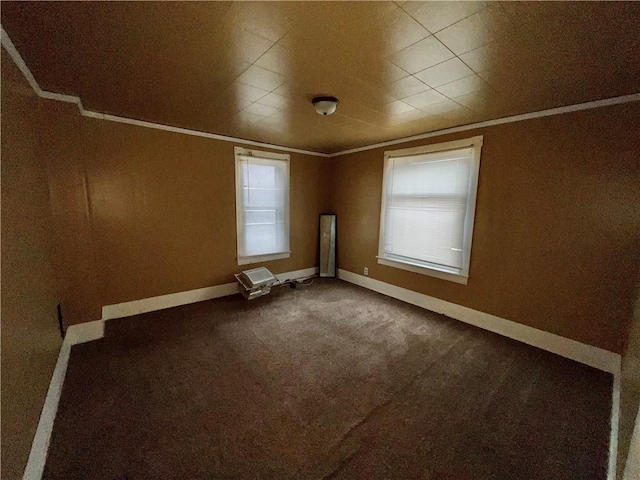 carpeted empty room with a wealth of natural light and crown molding