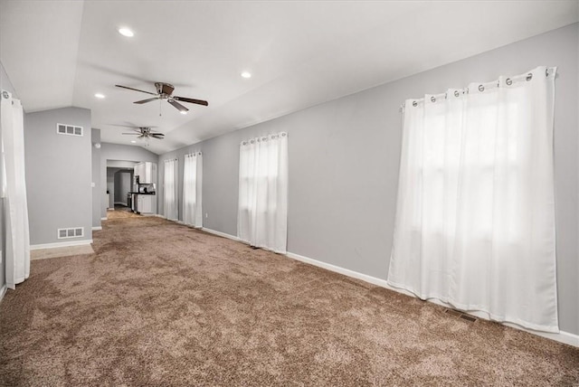 unfurnished living room with ceiling fan, lofted ceiling, and carpet floors