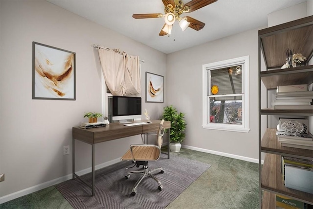 carpeted home office featuring ceiling fan