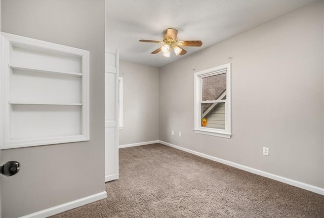 empty room featuring carpet and ceiling fan