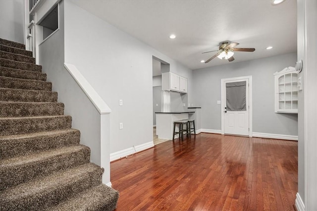 living room featuring ceiling fan and hardwood / wood-style flooring