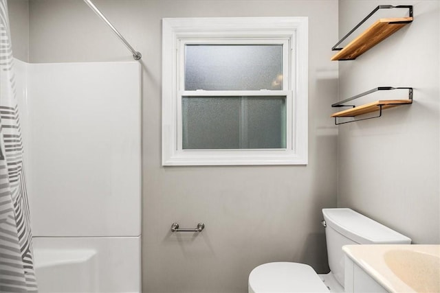 full bathroom with shower / bath combo, vanity, and toilet