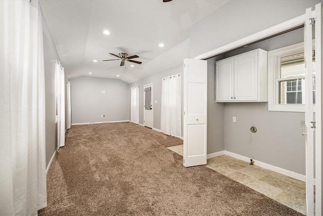 spare room featuring carpet floors, vaulted ceiling, and ceiling fan