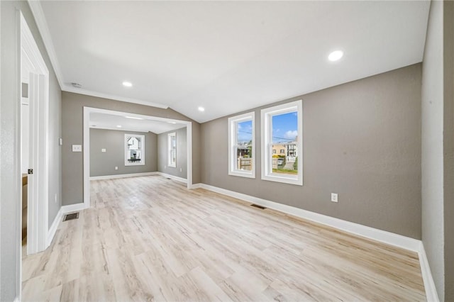 unfurnished living room featuring light hardwood / wood-style floors, lofted ceiling, and crown molding