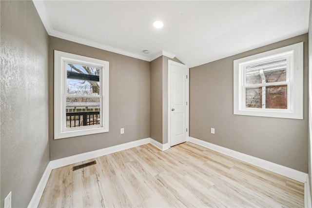 unfurnished room with light hardwood / wood-style floors and ornamental molding