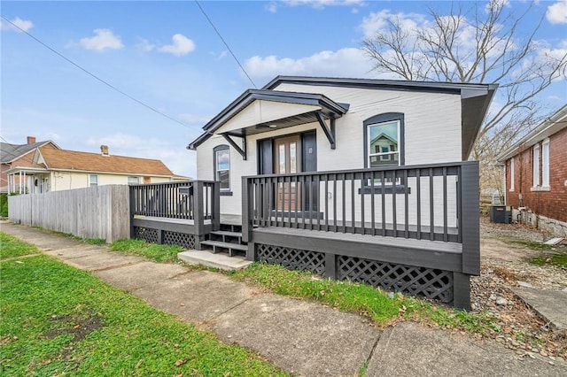 rear view of property featuring central AC and a deck