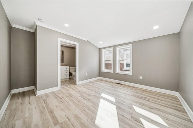 unfurnished bedroom featuring ensuite bath, crown molding, and light hardwood / wood-style flooring