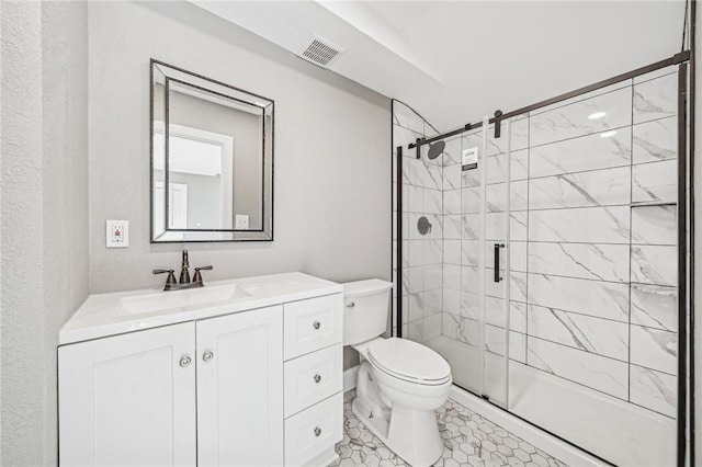 bathroom with vanity, toilet, and a shower with door