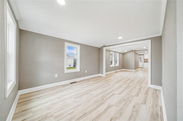 unfurnished room featuring light hardwood / wood-style floors and crown molding