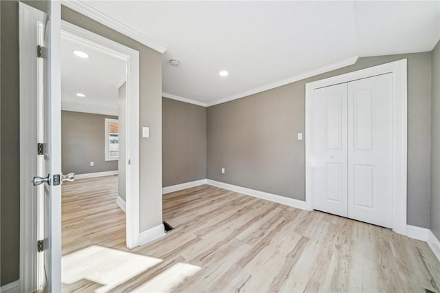 unfurnished bedroom with a closet, ornamental molding, and light hardwood / wood-style flooring