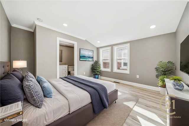 bedroom featuring ornamental molding, light wood-type flooring, ensuite bath, and lofted ceiling