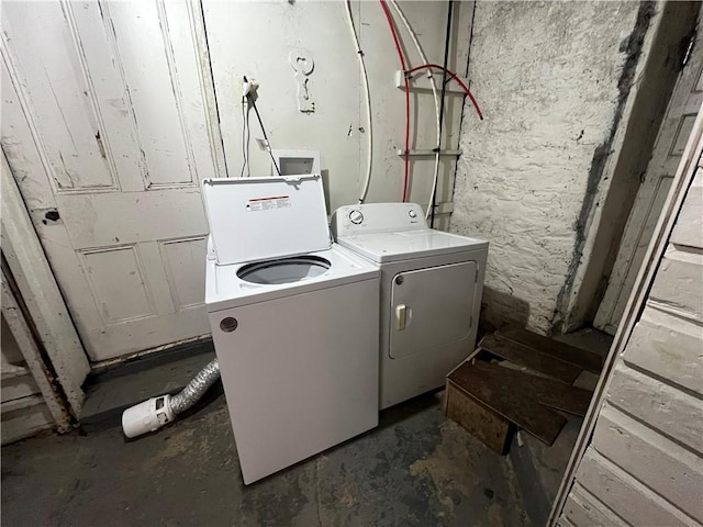 clothes washing area featuring separate washer and dryer