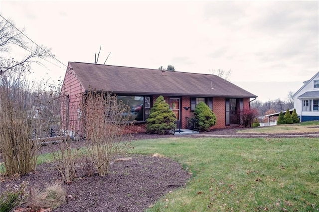 ranch-style home with a front lawn