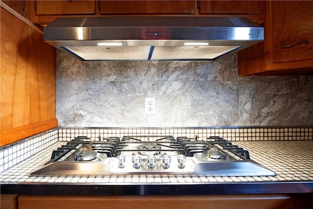 kitchen featuring decorative backsplash and stainless steel gas stovetop